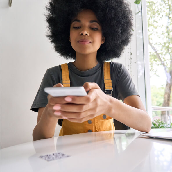 Woman scanning restaurant QR code