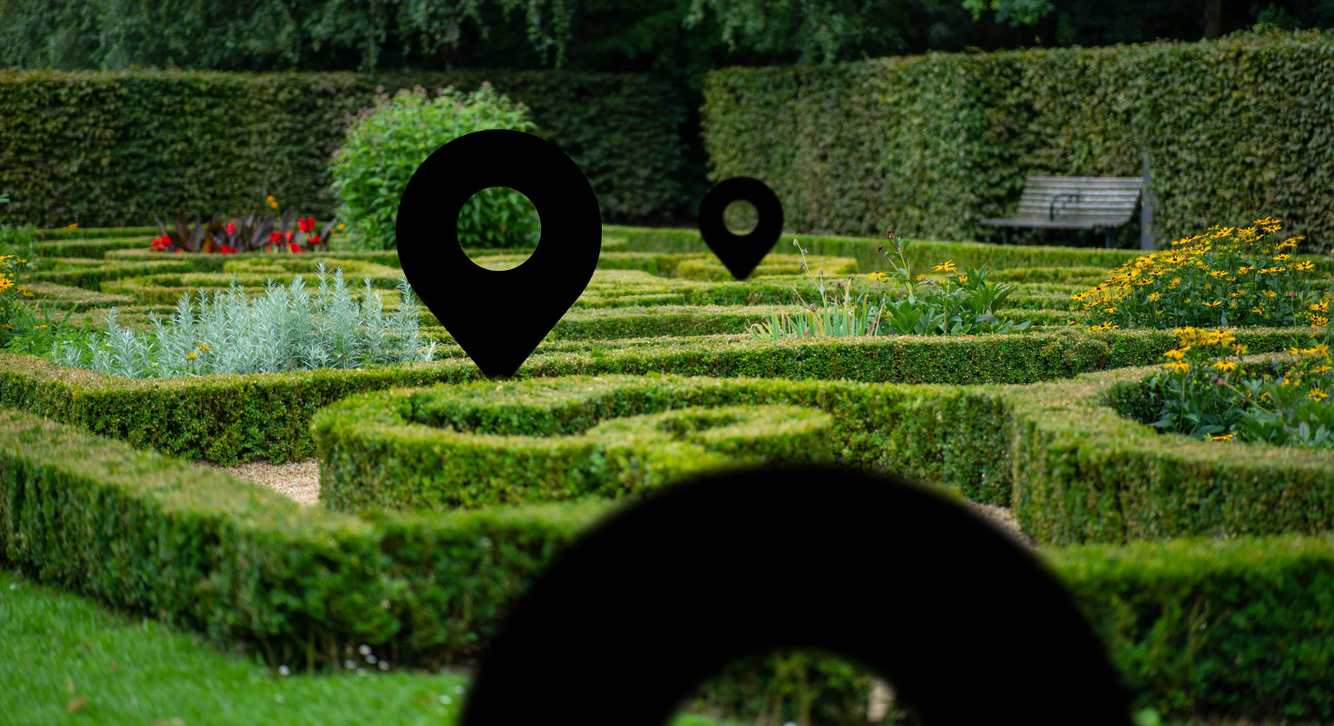 Well-manicured English style garden maze with location arrows inserted