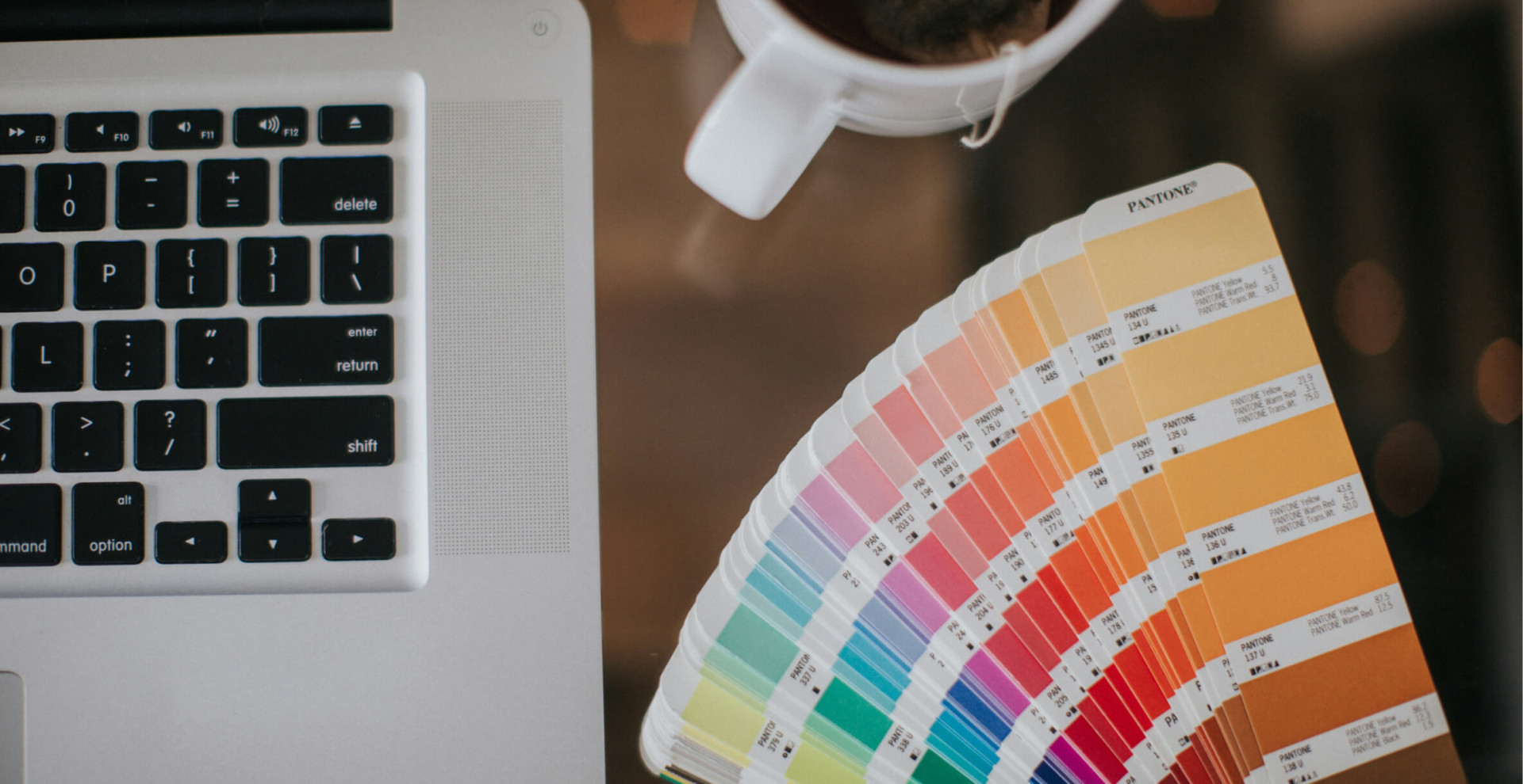 Keyboard, color wheel, and a mug of tea