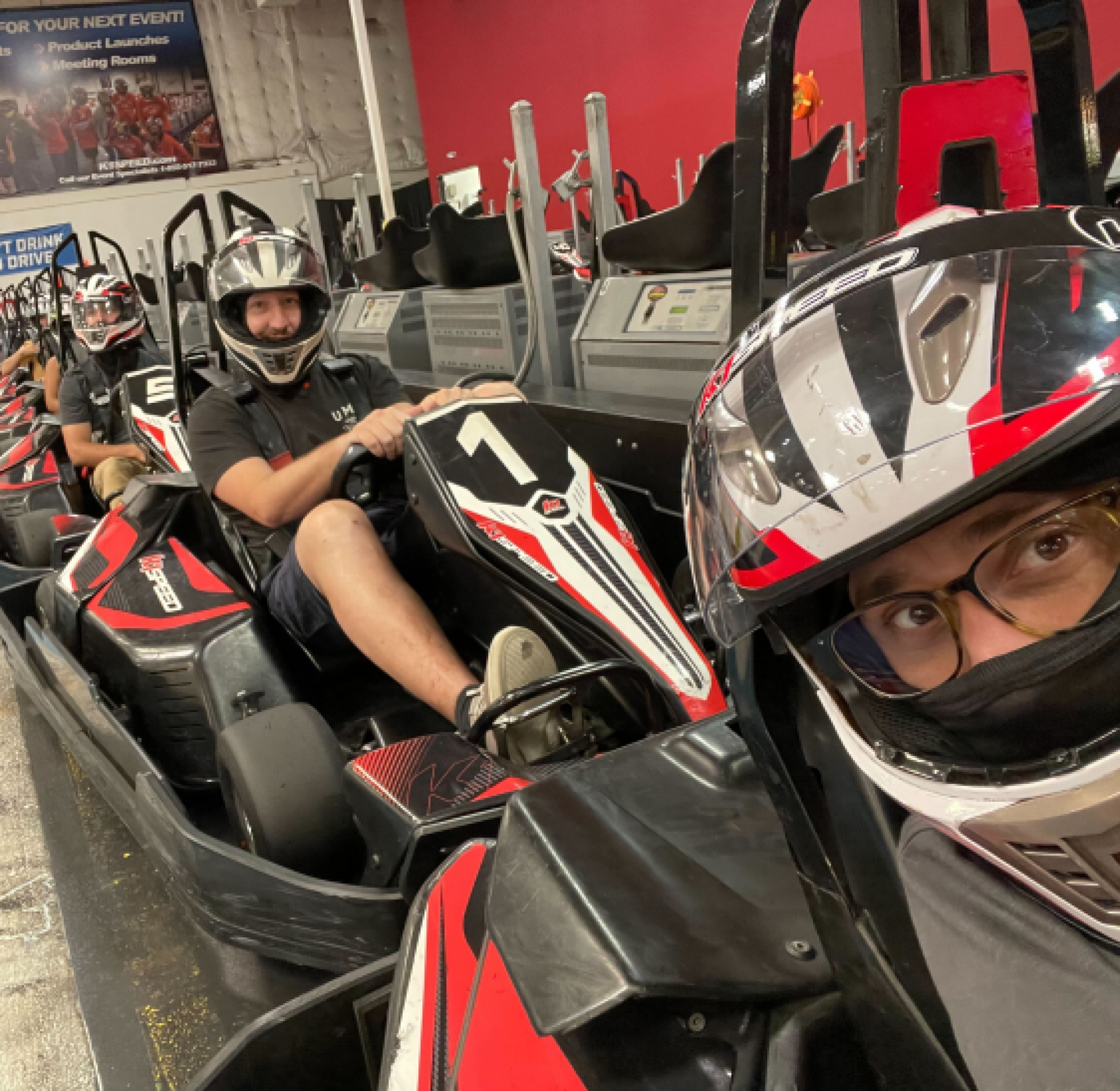 By the Pixel team members line up to race in red and black go-karts